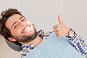 Happy patient using whitening gel